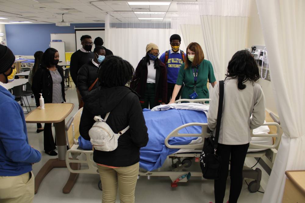 Students around hospital bed
